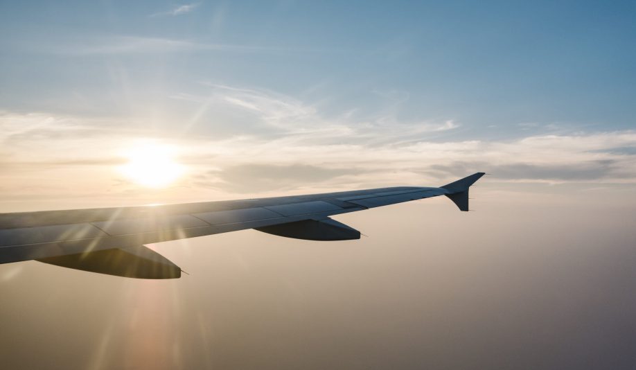 airplane wing and sunset on blue sky